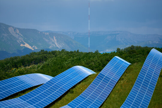 Curved shapes of solar panels on hill for PV photovoltaic electricity