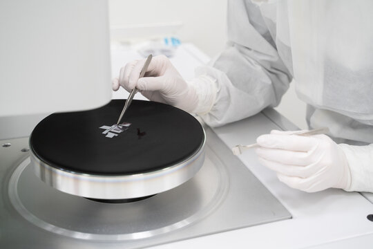 Anonymous Scientist Working With semiconductor Sample In Lab