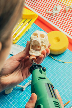 Modeler working on miniature model