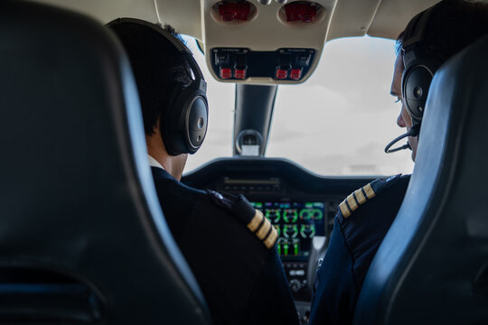 Cockpit With The Pilots Flying The Plane.