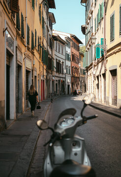 Fototapeta Typical italian narrow street with parked motor scooter