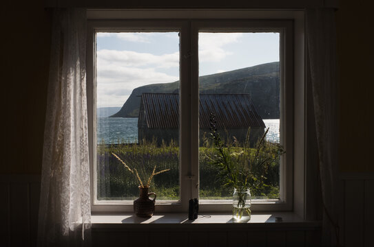 Fototapeta Gentle sunlight through a window, with a peaceful scene outside