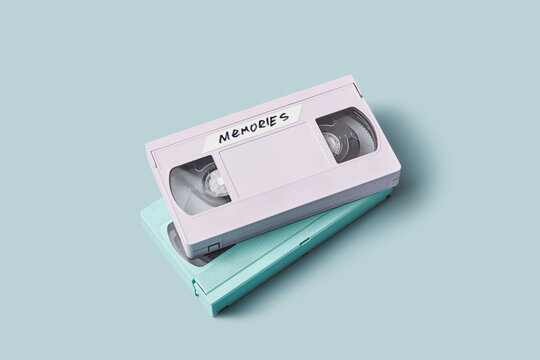 Two old tape VHS cassettes with word Memories over blue background