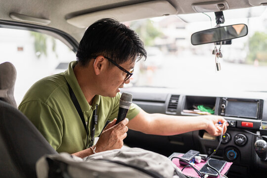 Male tourist guide with microphone.