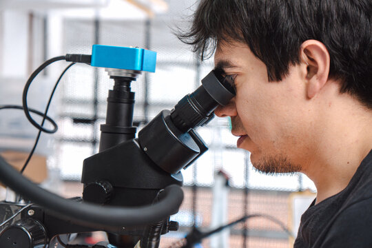 Man looking through a microscope