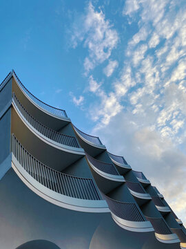 Curved balconies in a line viewed from the perspective below.