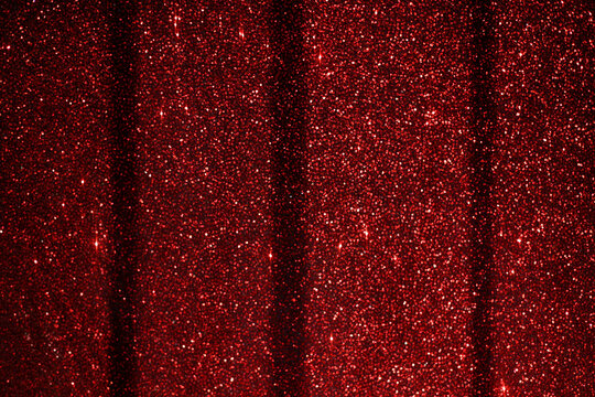 Red sequined fabric: detail of shiny cloth with shimmering effect