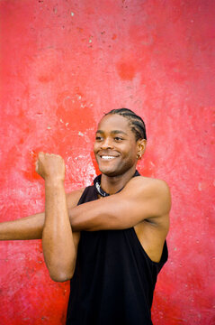 Film portrait of a black sportsman stretching outdoors