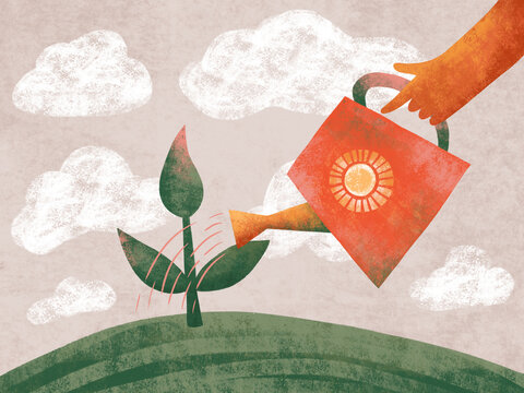 Cropped hand holding a watering can watering a sprout