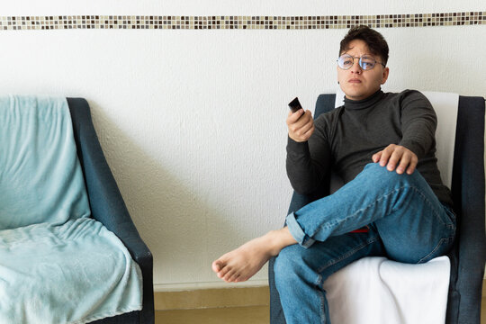 Man at home watching television.