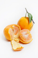 Tangerines or mandarin oranges (Citrus reticulata) are oranges that can grow in tropical and subtropical areas, randomly some are whole, some have been cut, with a white background