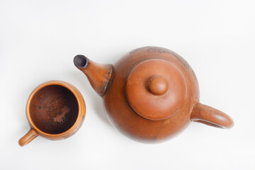 Teapot, place for brewing and drinking tea from terracotta, traditionally made, in white background