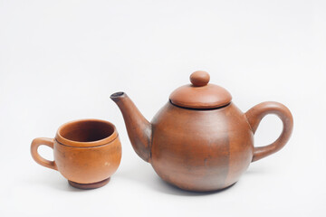 Teapot, place for brewing and drinking tea from terracotta, traditionally made, in white background