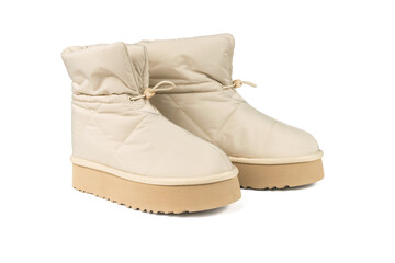 A pair of warm beige women's boots isolated on a white background.