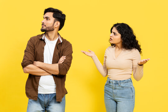 INDIAN COUPLE DISAGREEMENT Concept With Man Ignoring And Woman Arguing On Yellow Background