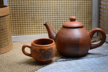 Teapots, teapots, places to brew and drink tea from terracotta, made traditionally, wooden background and natural wicker