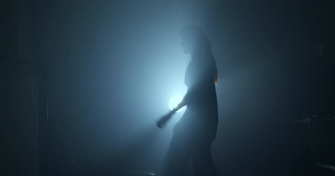 Shadow dancer video of a woman dancing in silhouette.
