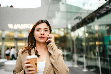 Business asian woman use smartphone internet connection in modern office city building