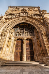 Medieval church facade highly decorated with stone carvings in Aranda de Duero, Burgos. - obrazy, fototapety, plakaty