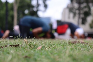 Muslims praying in the park on the grass