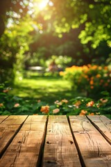 an empty wooden table set against a lush summer background, with a blurred green garden and a picnic or BBQ scene in the distance