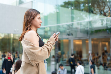 Business asian woman use smartphone internet connection in modern office city building - 777960403
