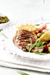 Grilled Turkey Breast with fresh salad. Bright background.	