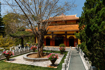 Beautiful Vietnamese temple in a flowering garden
