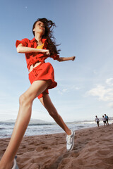 Joyful Run: Fashionable Woman Embracing Freedom and Happiness on a Beach