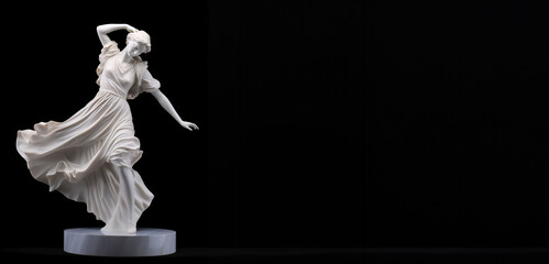 A classic white sculpture of a dancing woman positioned against a black background.