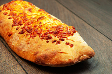 pita bread with cheese on a wooden background. pastries covered with cheese on a brown background