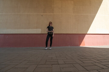 Portrait of a young beautiful long-haired girl outdoors in dark clothes.