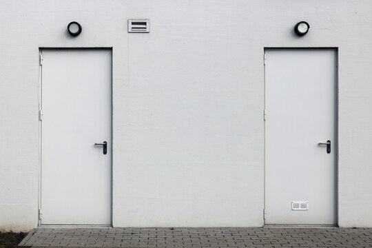 White wall with two closed doors
