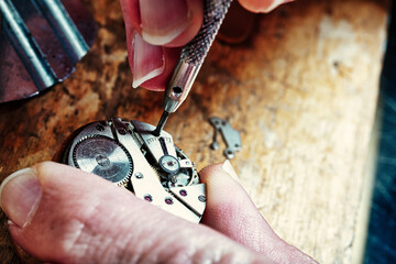 The horologist meticulously sets time's intricate dance