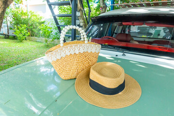Rattan bags and straw hat on vintage car in summer beach day ,summer knitted bag, fashionable...