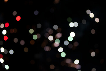 On a black background bokeh from explosions of colorful fireworks.