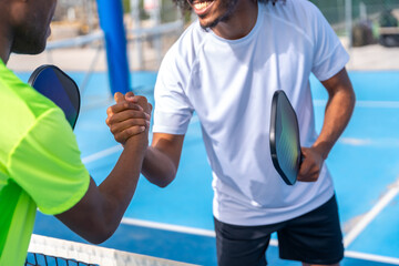 Pickleball rivals shaking hands before playing a match