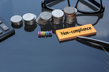 Business and risk concept. RISK and Non-Compliance are written on the colorful cubes and post-it...
