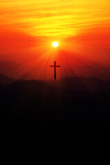Silhouette of christian cross on the mountain at sunset.