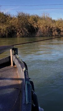 Traditional car ferry crossing the majestic Ebro River in Miravet. Is the last river ferry that allows crossing the Ebro River, consisting of two llaguts connected by a platform that can accommodate