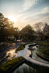 Sunset in the afternoon at Benchakitti Park. Golden hour view in the park with pathway and nature all around