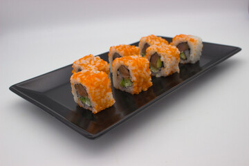 Modern Sushi Presentation on a Black Rectangular Plate