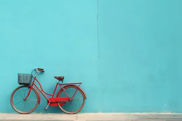 Foto op Plexiglas Fiets a red bicycle leaning against a blue wall