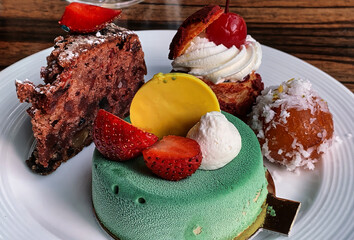 Assorted desserts in a white ceramic plate.