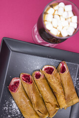 Sumptuous Hot Chocolate and Berry-Filled Crepes on a Vivid Pink Backdrop