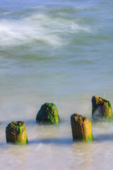 Seascape. Breakwater in the sun. Leba. Baltic Sea. Poland. - obrazy, fototapety, plakaty