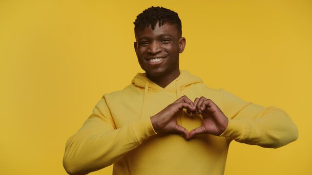 Joyful Man Making Heart Shape with Hands
