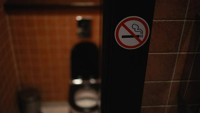 Smoke-free zone: A red sign with the words No Smoking in bold lettering stands out in the restroom of a public establishment, ensuring compliance with smoking policies