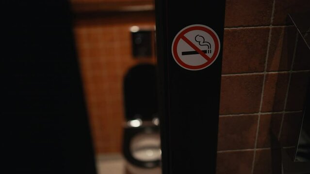 Tobacco-free zone: The sight of a red No Smoking sign in the restroom of a public establishment reinforces the establishment's commitment to a smoke-free environment