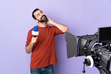 Reporter man holding a microphone and reporting news over isolated purple background thinking an...